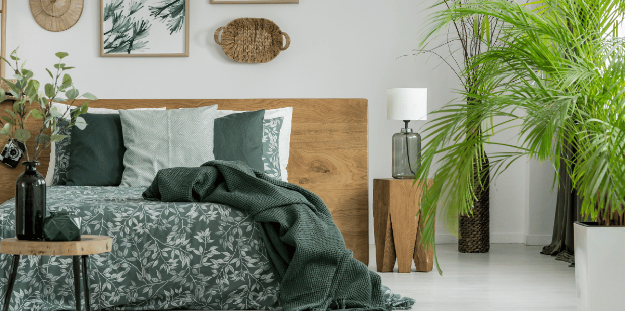 bedroom adorned with wooden furniture and table top and standing floor plants