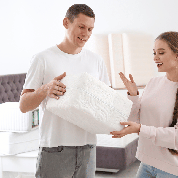 couple trying out a mattress sample thickness