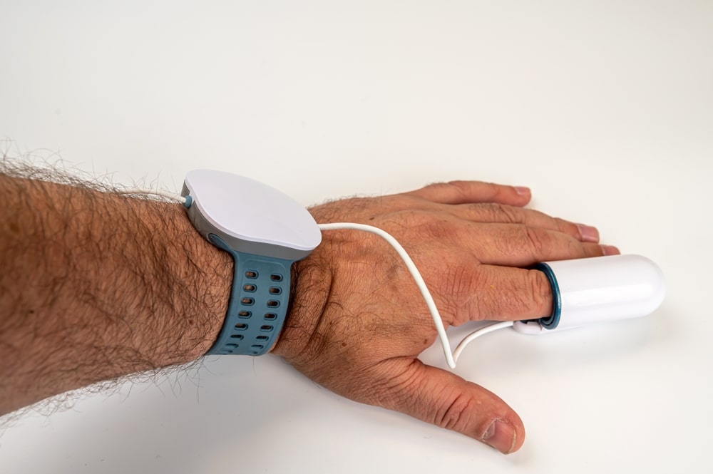 hand with pulse oxymeter on finger