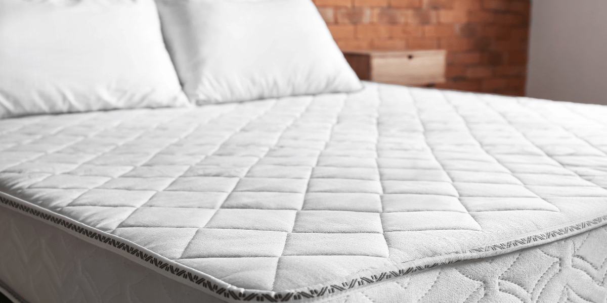 unrolled mattress in a box laid flat on frame