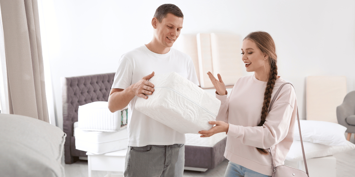 couple trying out a mattress sample thickness