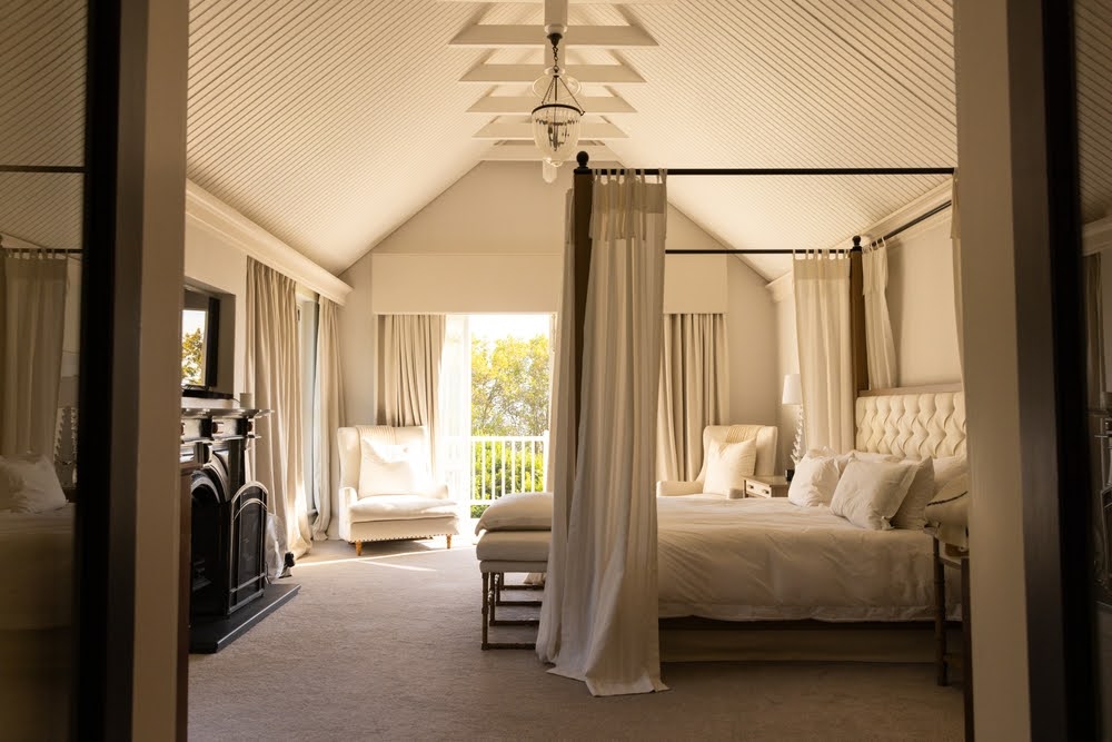 elegant bedroom with a platform bed and curtained frame