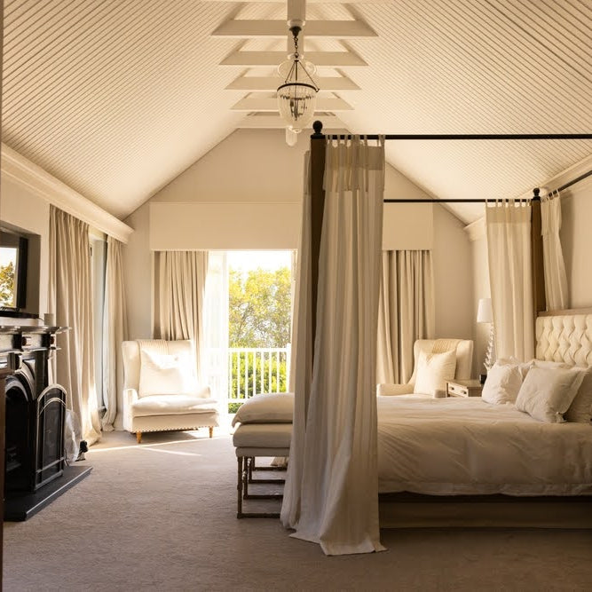 elegant bedroom with a platform bed and curtained frame