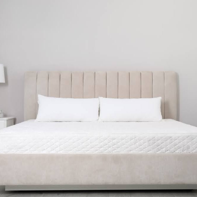  image of a new mattress on a bed frame without sheets or bedding