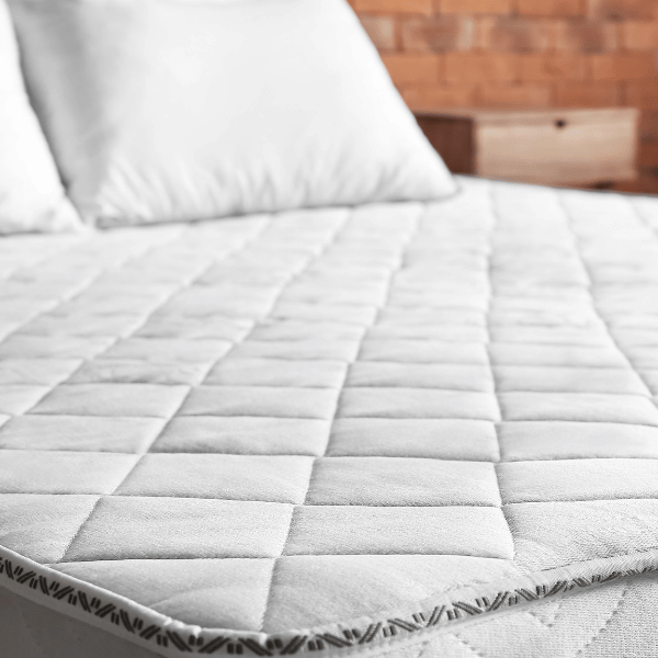 unrolled mattress in a box laid flat on frame