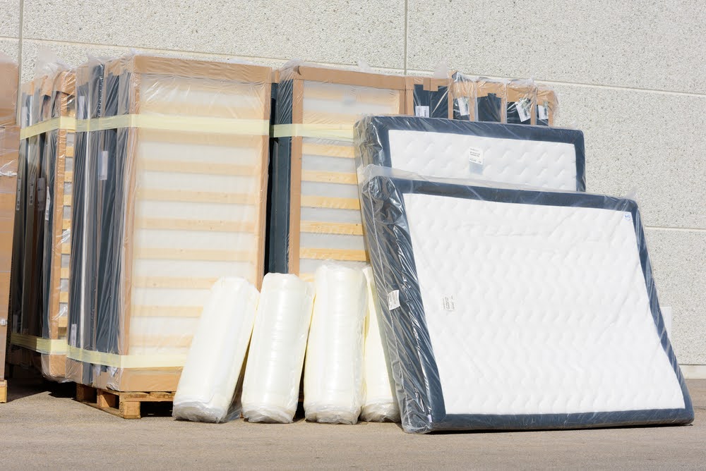 mattresses wrapped and stacked on a shipping pallet