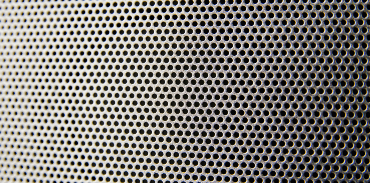 closeup of the speaker mesh of a white noise machine