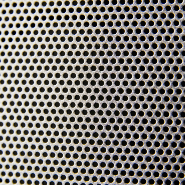 closeup of the speaker mesh of a white noise machine