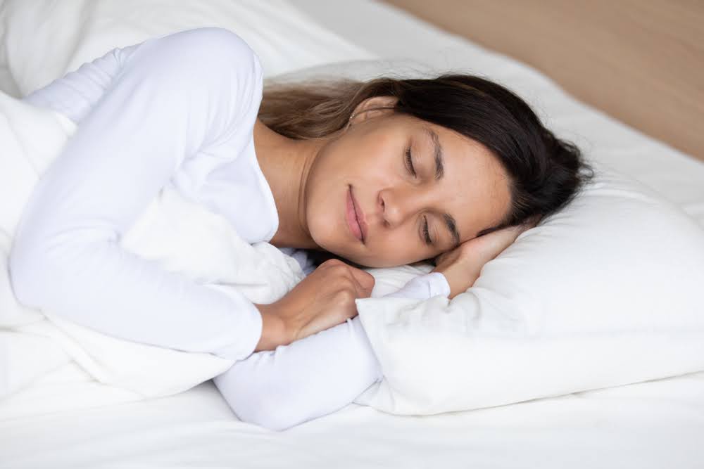 woman laying on her side on a memory foam mattress